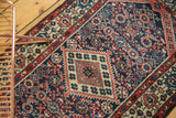 Hand knotted Vintage Borchalou rug with navy field, red and ivory Herati and boteh motifs.