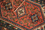 Vintage Borchalou rug detail, dark blush Herati motif field with blue and ivory borders.