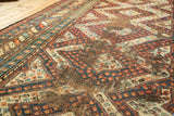 Worn vintage Caucasian rug runner, madder red and navy geometric patterns with foundation showing.