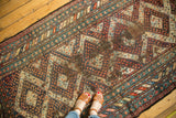 Geometric patterns and colorful botehs with areas of heavy foundation on a Caucasian rug.