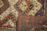Folded vintage Caucasian runner, revealing geometric diamond pattern, colorful botehs, and detailed foundation.
