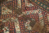 Colorful geometric pattern on a hand knotted Caucasian rug runner with heavy foundation wear.