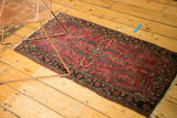 Vintage Sarouk rug's cherry red allover blossoms and dark navy border.