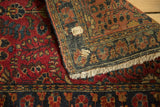 Vintage Sarouk rug's hand-knotted reverse, revealing its weave, original mending, and wear.