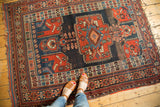 Playful, intricate geometric patterns and a replete array of colors on this antique Kamseh rug.