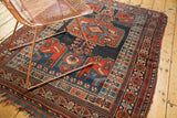 Hand-knotted antique Kamseh rug border with geometric motifs, rich colors, and tattered fringe.