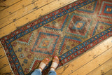 Vintage Bakshaish runner's geometric diamond medallions with serrated relief, madder red, sky blue, camel.
