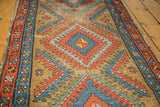 Serrated diamond motif on vintage Bakshaish rug showing wear, red, sky blue, camel tones.