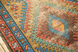 Geometric serrated diamond pattern on Vintage Bakshaish runner in sky blue, madder red, and camel.