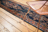 Antique Lilihan runner with navy blue indigo ground, blush florals, and flayed terra cotta border.