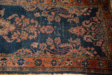 Antique Lilihan runner detail with navy blue ground, terra cotta flayed floral border, and distress.