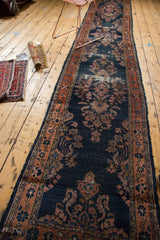 Navy blue ground of the antique Lilihan runner shows blush floral motifs and distress.