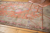Worn pile of an antique Khotan carpet showcasing upbeat terra cotta and pink floral motifs.