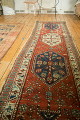 Antique Persian runner: madder root red field, stylized motifs, navy, ivory border, tattered side.