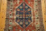 Detail of antique North West Persian runner: navy hexagonal medallion, flora, birds, aged pile.