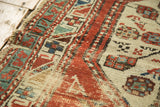 Antique North West Persian rug with worn pile texture, madder red, ivory, sea foam geometric motifs.