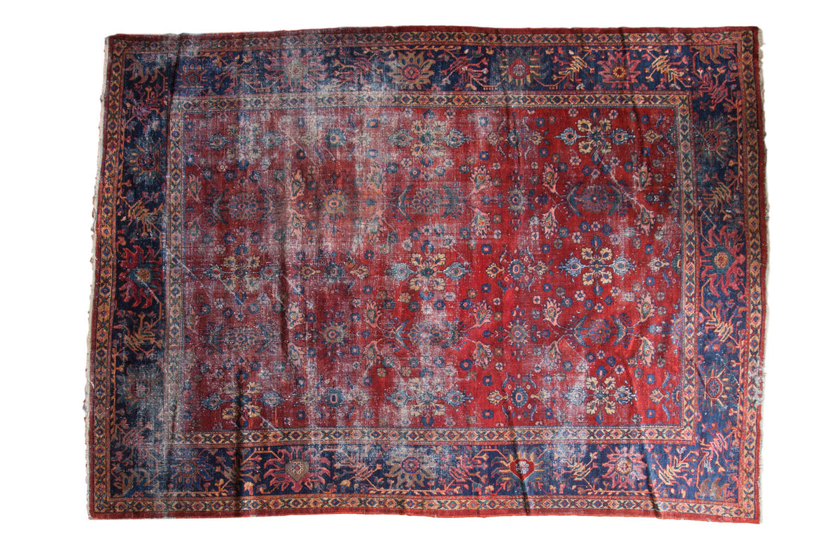 Distressed vintage Mahal carpet, allover floral design on cherry red and navy blue, 9'1" x 12'.