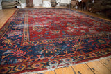 Vintage Mahal carpet: Artfully distressed navy border with saffron and cherry red floral motifs.