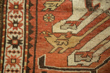 Oversized scaled eagle Kazak motif and narrow border detail on a hand-knotted vintage rug.