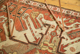 Oversize geometric motifs in rust, ivory, and charcoal on this vintage Kazak rug.