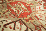 Rust, beige, and charcoal geometric patterns with hand-knotted texture on vintage Kazak rug.