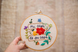 Mi Casa Es Su Casa hand-embroidered hoop art featuring colorful flowers and green leaves.