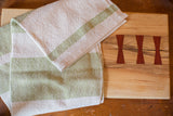 Handwoven Loomination lime and cream cotton dish towel with feedsack stripe pattern.