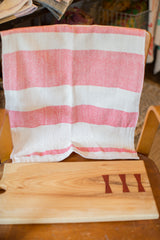 Textural weave on a handwoven red and white striped cotton dish towel.