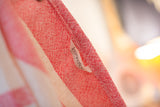 Loomination label on the handwoven red and white cotton dish towel.