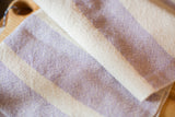 Detail of handwoven lavender cotton dish towel with natural stripe texture.