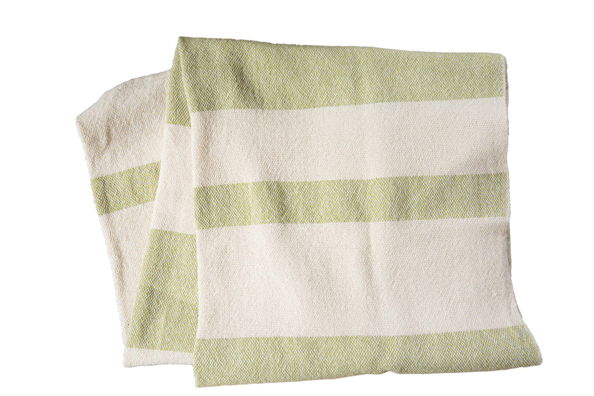 Hand-woven spa towel throw with wide, textured stripes in lime green and cream.