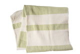 Hand-woven spa towel throw with wide, textured stripes in lime green and cream.