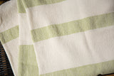 Absorbent, textured weave of the hand-woven cotton spa towel in lime and cream stripes.