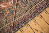 Detailed floral border and low, even pile of an antique Persian Kermanshah carpet.