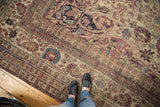 Mostly even wear showing on the time-softened floral borders of an antique Persian carpet.
