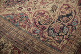 Close view revealing the mostly even wear to knot heads in the floral motif of an antique Kermanshah carpet.