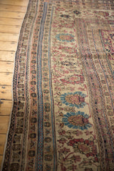 Floral guard bands of an antique Kermanshah rug with visible wear down to the knot heads.
