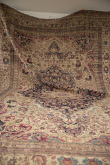 Draped view of a late 19th-century Persian Kermanshah, highlighting its supple hand and grand scale.