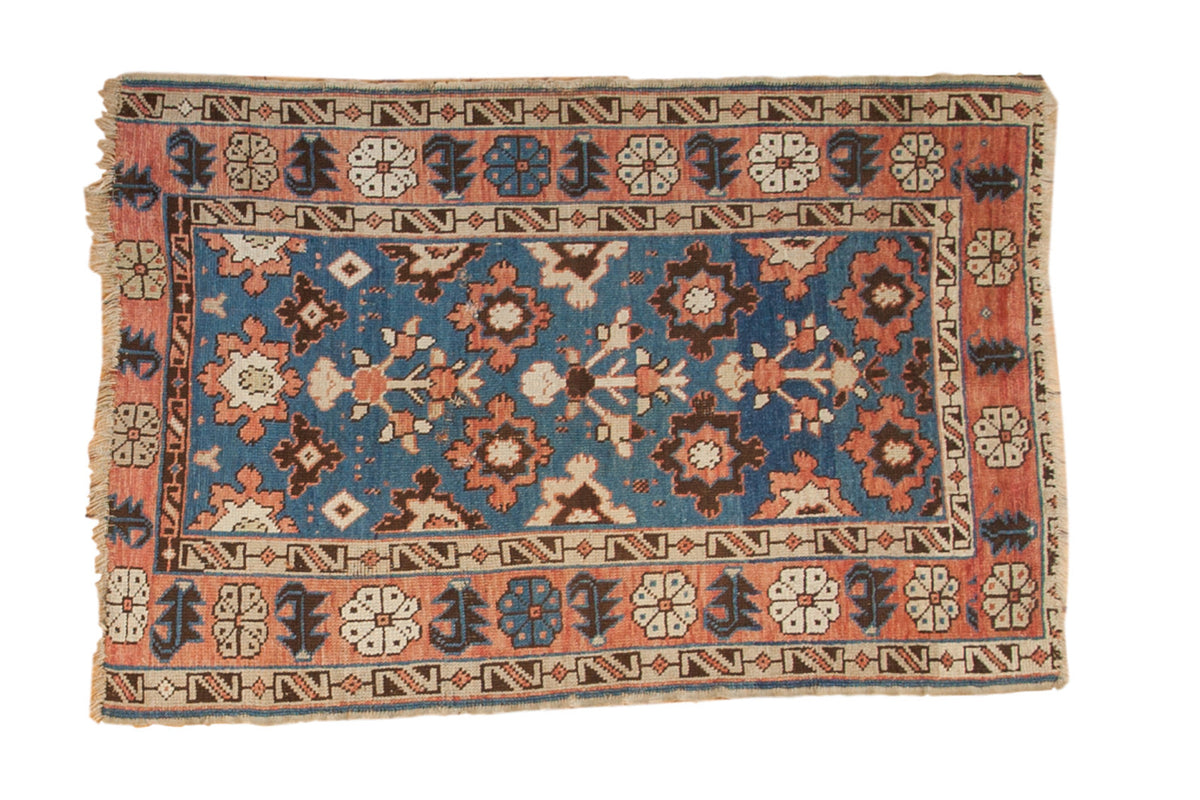 Vintage Caucasian rug, sky blue allover field with blossoming plants, terra cotta and ivory patterns.