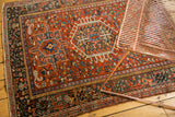 Vintage Karaja rug with brick red, blue, and teal geometric and curvilinear motifs.
