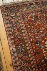Secured side and intricate geometric patterns of a brick red vintage Karaja rug.