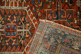 Vintage Karaja rug corner showing finely woven foundation, geometric red, blue, and teal patterns.
