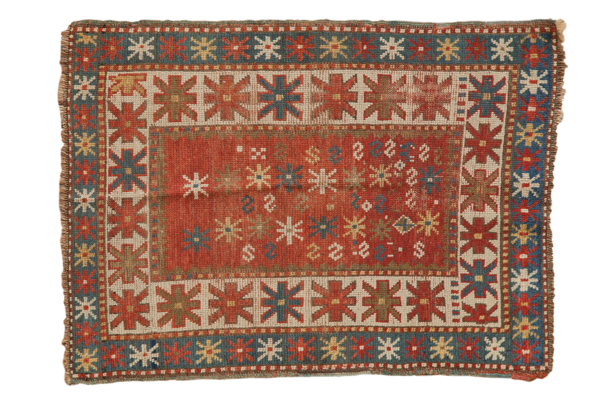 Antique Kazak rug mat, playful animal, serpent field, starburst borders, red, blue, beige.