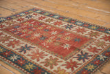 Original side cord selvedge and geometric starburst border of an antique Kazak rug mat.