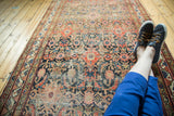 Antique Hamadan rug runner with allover herati design, distinct abrash, and muted gem-tone colors.