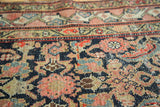 Visible abrash on the antique Hamadan runner's hand-knotted herati pattern with even wear.