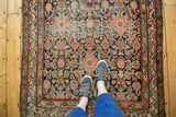 Antique Hamadan runner's detailed herati design, abrash, and visible wear underfoot.