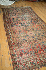 Antique Hamadan rug corner, herati pattern, rich pomegranate, navy, antique ivory tones, and tattered edge.
