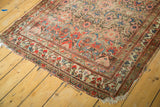 Antique Hamadan runner corner with pomegranate red Herati pattern, meandering leaf borders, and tattered end.