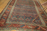 Antique hand-knotted Kurdish Bijar rug detail, showcasing henna plant design in indigo, apricot, and green.